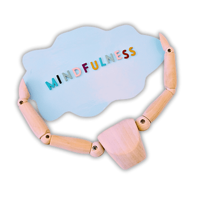 a wooden figure holding a card cloud saying midfulness