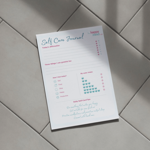 a peice of paper on a tiled floor with wording relating to a self care journal daily checklist